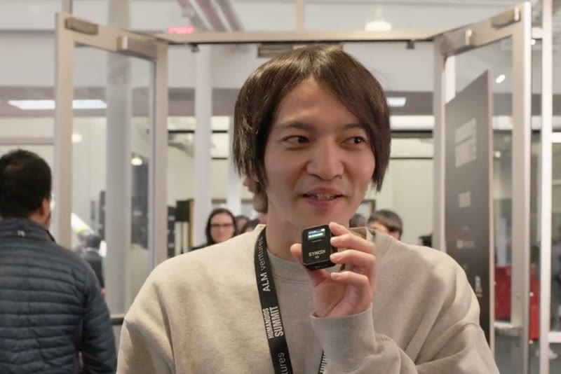 An attendee speaking into a handheld mic during an on-site interview