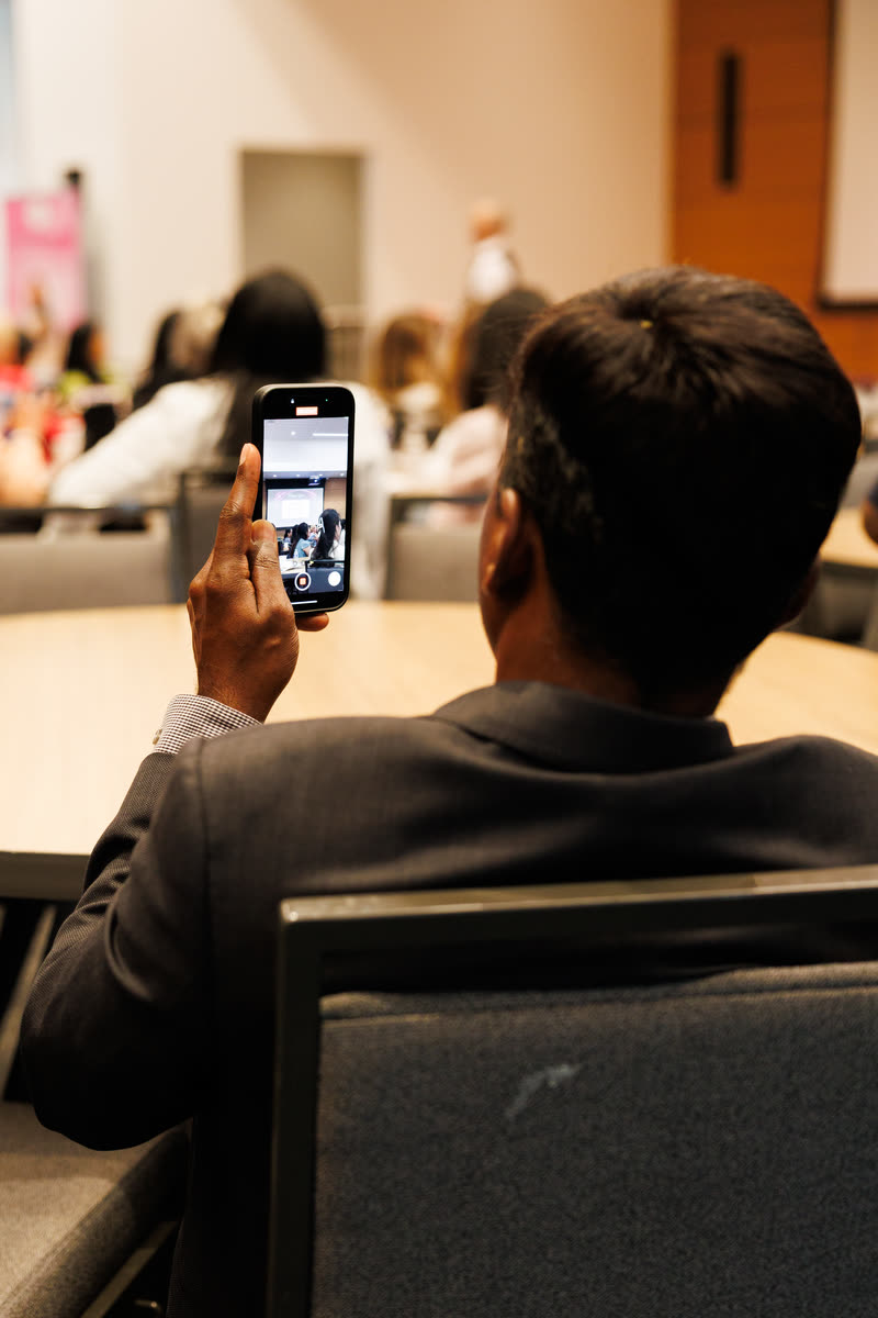 An attendee filming the stage on his phone