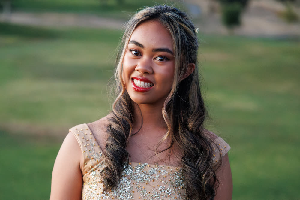 A close portrait of the debutante smiling outdoors