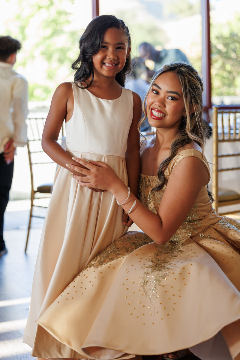 Two sisters laughing together before the program