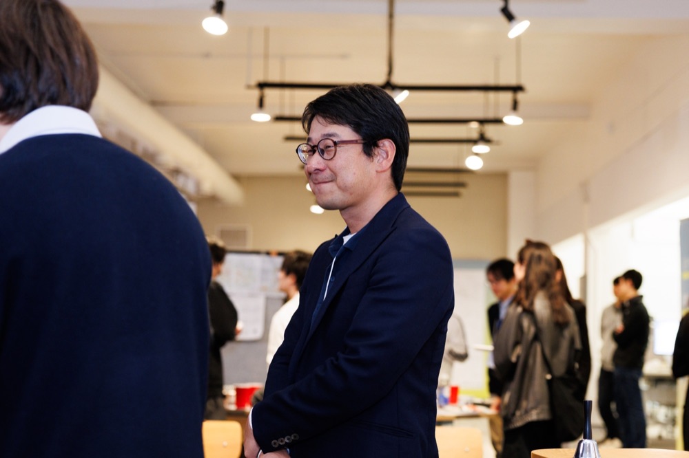 An attendee in conversation in a busy room
