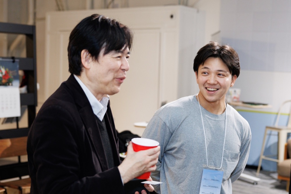 Two attendees laughing during a networking break